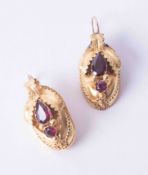 A pair of ornate yellow gold Continental style earrings set almandine garnet with leaf design and