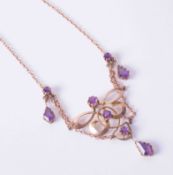 An ornate Edwardian Art Nouveau style rose gold necklace set amethysts, 6.6g.