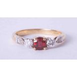 An 18ct yellow gold three stone ring set approx. 0.36 carat ruby and 0.35 carat diamonds (total