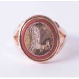 An antique 9ct rose gold signet style ring set with a mosaic of a resting dog, finger size M.