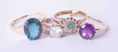 A set of four dress rings including a 9ct white gold ring set cubic zirconia, finger size M, a 9ct