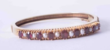 A good antique ruby & pearl claw set bangle with safety chain.