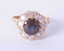 An 18ct yellow gold diamond (approx. 1.10 carat) and dark sapphire (approx. 1.30 carat) cluster