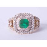 An impressive & ornate 18ct yellow gold emerald (approx. 1.50 carat) and diamond cluster ring set in