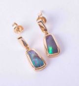 A pair of modern 18ct yellow gold drop earrings set black opal with butterfly backs, approx. 3.40g.