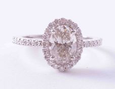 An 18ct white gold halo ring set 1.51 carat oval diamond, colour H to I, clarity SI1 to SI2,