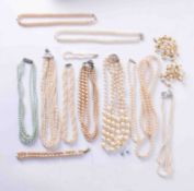 A box of various costume jewellery faux pearl necklaces.