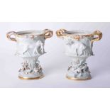 A pair of ornate Continental porcelain vases richly embellished with hunting subject matter and gilt