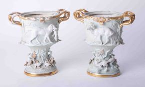 A pair of ornate Continental porcelain vases richly embellished with hunting subject matter and gilt