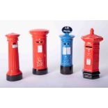 Four Royal Mail money bank models of post boxes.