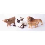 A Beswick Lion cub, a pair of Siamese cats together with a Highland bull, damaged, (5 items).