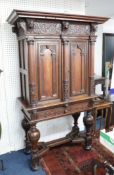 A Continental Dutch? Carved oak cabinet, on stand, the base with bulbous legs and shaped structures,