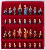 A modern novelty chess set in the form of Emperors New Clothes, boxed.