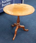 A 19th Century mahogany tripod wine table with tip up top.