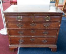 A Georgian mahogany bachelors chest fitted with a brushing slide over two short and three long