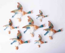 A collection of 7 various size Beswick flying ducks, the largest model 596, length 25cm.