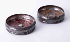 A pair of silver wine bottle coasters, diameter 13cm.