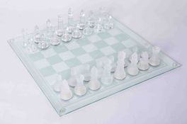 A modern clear and frosted glass Chess set and board.