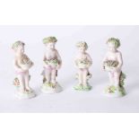 A group of four porcelain cherubs, heights 9cm to 10cm.