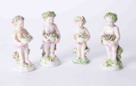 A group of four porcelain cherubs, heights 9cm to 10cm.