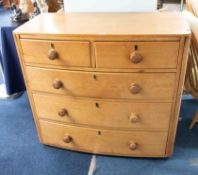 An antique five drawer pine bow fronted chest of drawers, height 92cm, width 102cm.