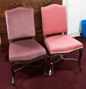 A pair of French style bedroom chairs in carved wood frames, non matching upholstery.