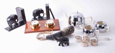 A pair of black ebony elephant bookends, a chrome and ceramic Deco teaset, a horn, a clock barometer