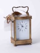 A 20th century brass cases carriage clock with platform movement and key, the dial marked Angelus,