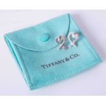 A pair of Silver Tiffany & Co "Loving Heart" Earrings by Paloma Picasso, with post & butterfly