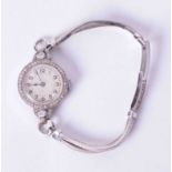 A ladies 9ct white gold Art Deco diamond set cocktail watch with a platinum back plate (stamped