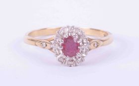 A 9ct yellow & white gold cluster ring set approx. 0.35 carats of ruby surrounded with small