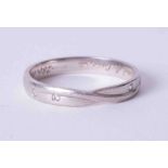 A platinum twist design band set four small spaced diamonds, weight approx. 2.8g, size L.