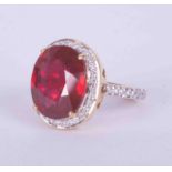 An 18ct yellow gold cocktail ring set a large ruby style stone measuring approx. 14.5mm x 12.5mm,