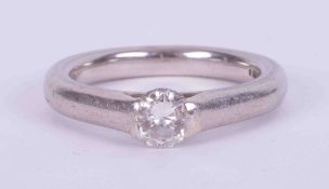 A platinum ring set with a tension set round brilliant cut diamond approx. 0.50 carats, colour G-H