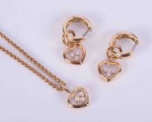 A jewellery suite by Chopard 'Happy Diamonds' to include a pair of 18ct yellow gold heart drop