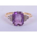 An 18ct yellow & white gold ring set with a fancy rectangular cut Amethyst, approx. 3.80 carats with
