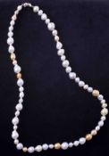 A 28" strand of champagne & white baroque south sea pearls ranging from 14mm down to 8mm strung to a