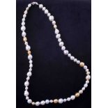 A 28" strand of champagne & white baroque south sea pearls ranging from 14mm down to 8mm strung to a