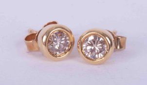 A pair of 18ct yellow gold rub over studs set a total weight of 0.50 carats of round brilliant cut