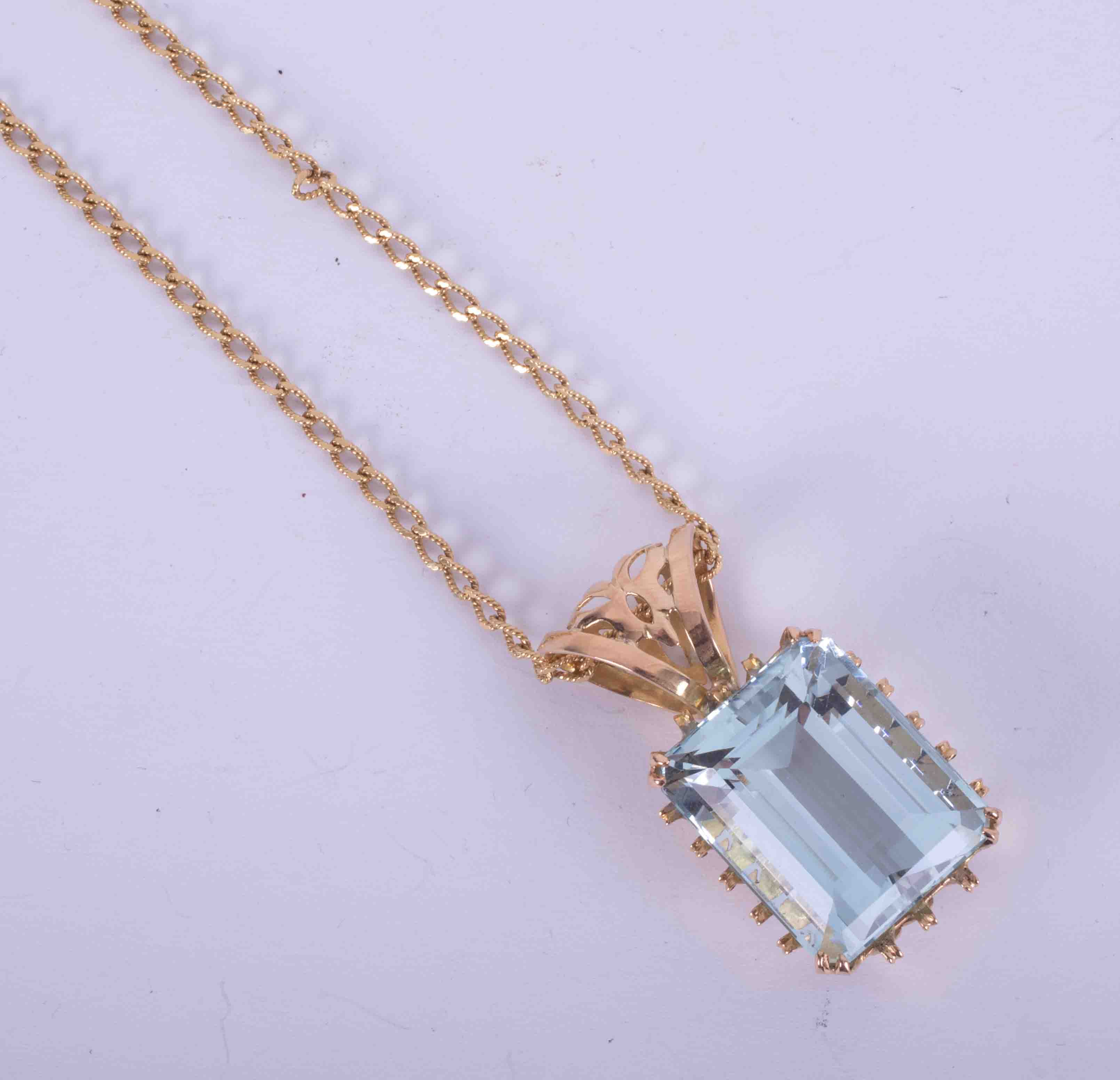 An impressive & ornate 18ct yellow gold pendant set approx. 30 carats of emerald cut Aquamarine with