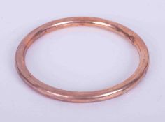 A 9ct rose gold hollow bangle, weight 11.28g.