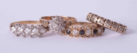 Four 9ct yellow gold stone set rings including cluster style & half eternity style rings, total