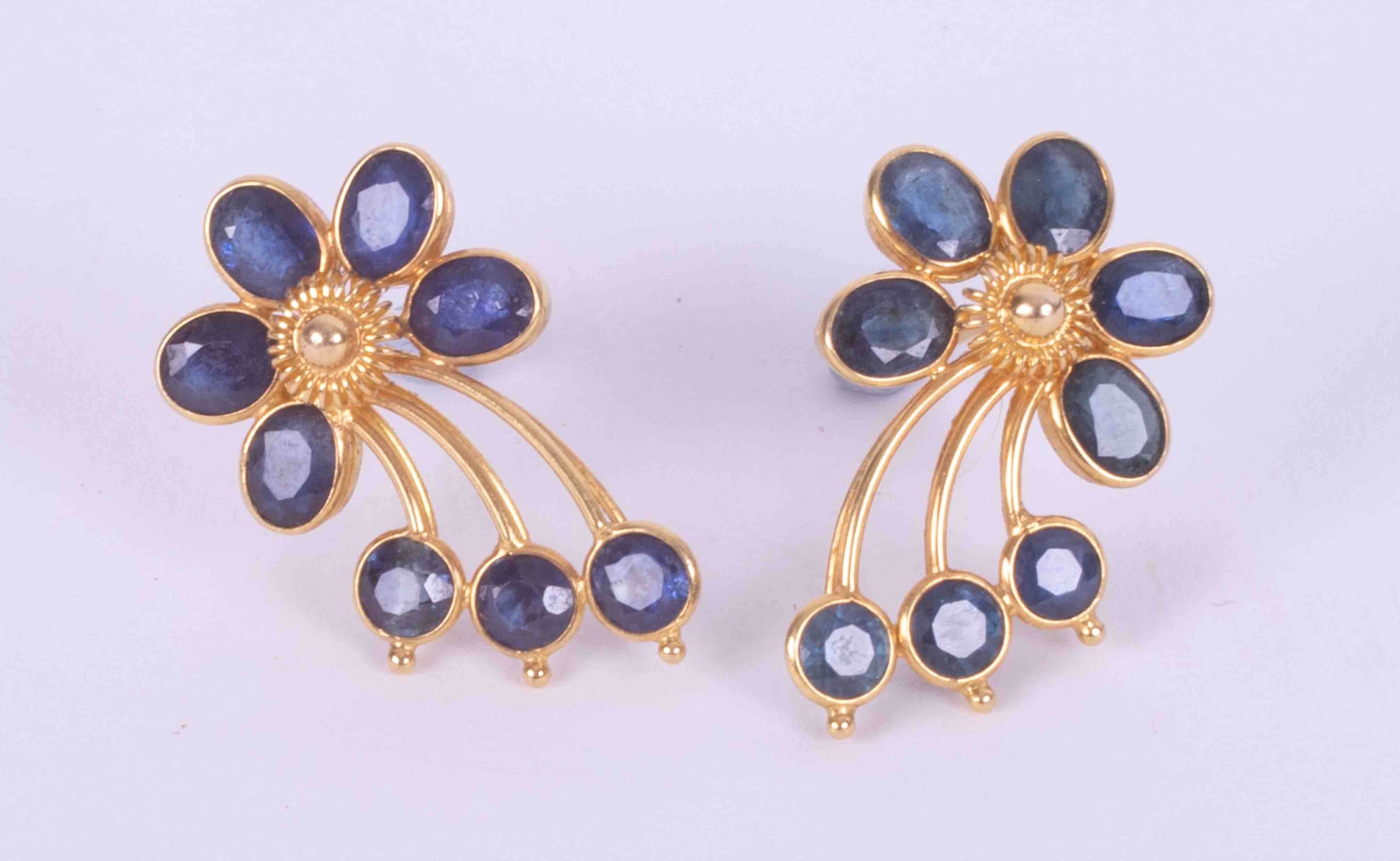 A pair of high carat (not tested) yellow gold flower earrings set with a mixture of oval and round