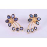 A pair of high carat (not tested) yellow gold flower earrings set with a mixture of oval and round