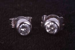 A pair of 18ct white gold rub over set stud earrings set approx. total weight 0.20 carats of round