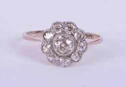 An antique 18ct white gold flower cluster style ring set approx. 0.55 carats of old cut diamonds,