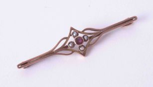 An antique 9ct yellow & rose gold bar brooch set with seed pearls and a small almandine garnet,