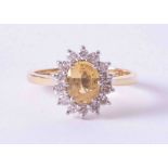 An 18ct yellow & white gold cluster ring set approx. 0.85 carat oval yellow sapphire surrounded by