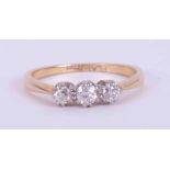 An 18ct yellow gold & platinum three stone ring set with approx. 0.22 carats of round brilliant
