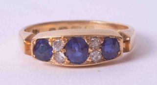 An antique 18ct yellow gold ring set three old cut slightly oval sapphires, total weight approx. 0.